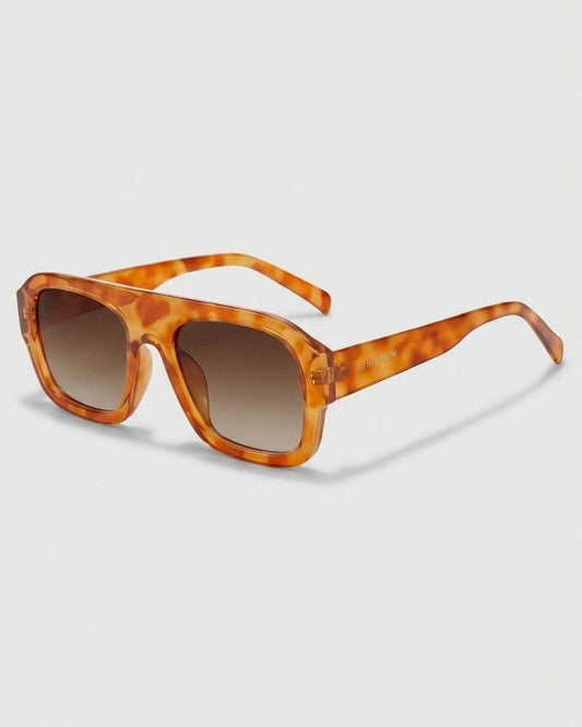 Tortoiseshell sunglasses with brown gradient lenses on a light gray background