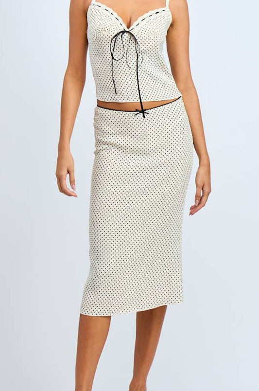 Woman wearing a polka dot dress with a white background