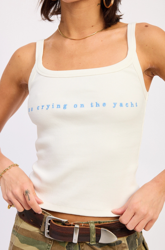 Person wearing a white tank top with text on a plain background