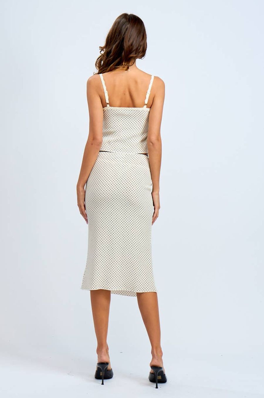Woman wearing a polka dot dress on a white background